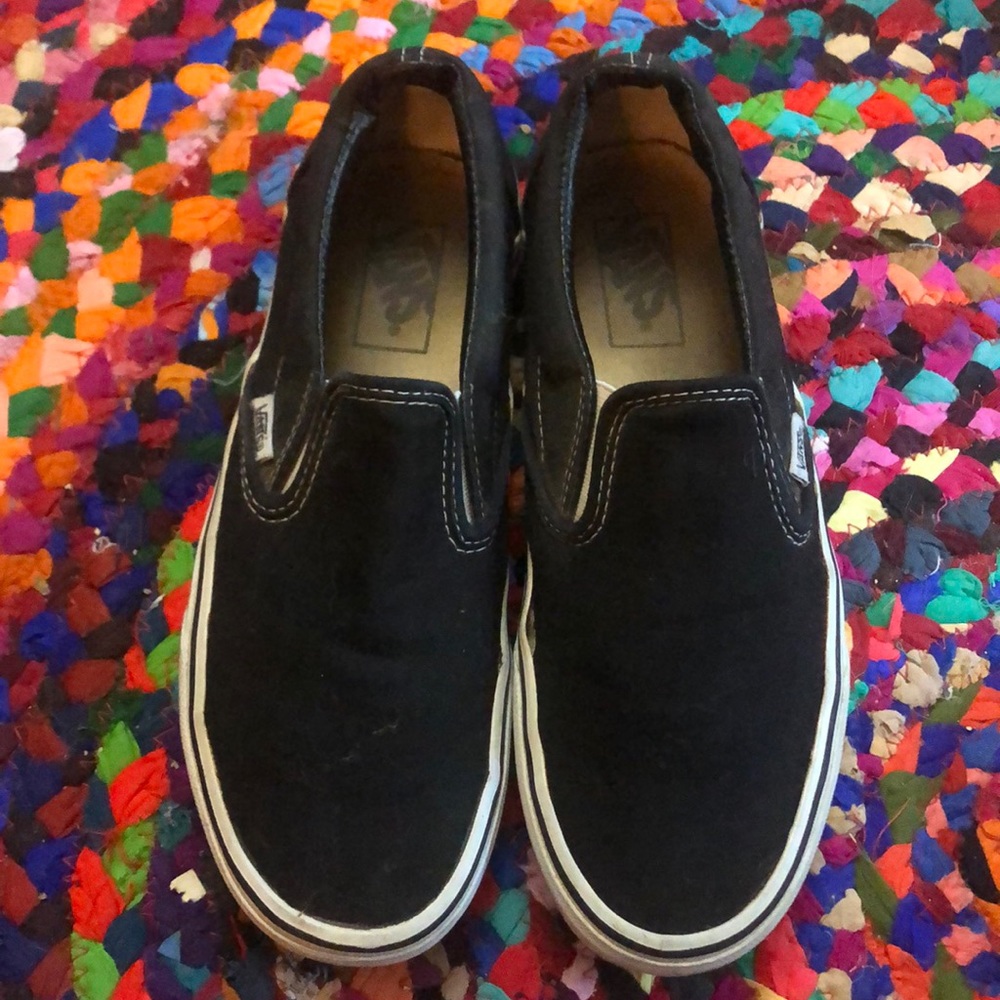 Black and white Vans slip-on sneakers